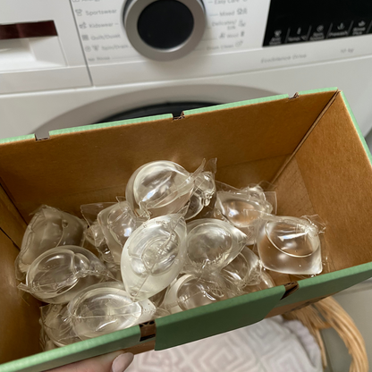 An open box of Ecyo eco laundry pods.